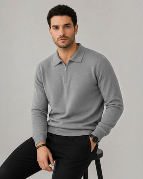 Modelo vestindo suéter Habitat Masculino Valdieri cinza de lã com gola polo e zíper, sentado em fundo neutro.